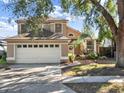 Charming two-story home featuring a two car garage, neutral color palette, and a well-manicured front yard at 380 Morning Glory Dr, Lake Mary, FL 32746