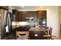 Modern kitchen featuring granite countertops, stainless steel appliances and an island with seating at 4110 Arlington Ridge Blvd, Leesburg, FL 34748