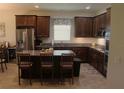 Bright kitchen featuring granite countertops, a stylish island, and stainless steel appliances at 4110 Arlington Ridge Blvd, Leesburg, FL 34748