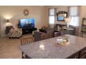 Inviting living area with neutral colors, comfortable seating, and natural light, adjacent to kitchen at 4110 Arlington Ridge Blvd, Leesburg, FL 34748