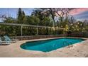 Inviting backyard pool area with lounge chairs for relaxation, surrounded by lush greenery for privacy at 48 Carriage Hill Cir, Casselberry, FL 32707