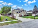 Corner lot home with a three car garage and a well maintained lawn with mature trees at 558 Osprey Lakes Cir, Chuluota, FL 32766