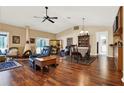 Open-concept living room featuring vaulted ceilings, hardwood floors, fireplace, and dining area at 600 Heather Brite Cir, Apopka, FL 32712