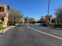 View of community entrance and gatehouse with well maintained landscaping at 8801 Villa View Cir # 207, Orlando, FL 32821