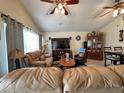 Spacious living room showcasing two couches, a ceiling fan, and a large window for natural light at 9329 Dearmont Ave, Orlando, FL 32825