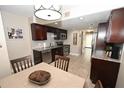 Featuring a breakfast nook adjacent to kitchen with dark cabinets, stainless steel appliances, and granite countertops at 1009 Troon Trce, Winter Springs, FL 32708