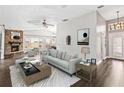 Bright living room with modern furnishings, fireplace, ceiling fan, and light gray, textured area rug at 1071 Sweet Tree Ct, Apopka, FL 32712