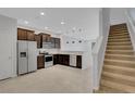 Spacious open kitchen with dark wood cabinets, stainless steel appliances, and tiled floors at 1117 Pavia Dr, Apopka, FL 32703