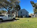 Exterior shot of condo building featuring manicured landscaping and a white pickup truck at 1324 S Pine Ridge Cir # D2, Sanford, FL 32773