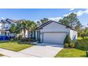 Charming single-story home with a two-car garage, well-manicured lawn, and welcoming curb appeal at 17216 Goldcrest Loop, Clermont, FL 34714