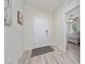 Welcoming foyer with tile flooring, neutral paint, and door to bedroom on the right at 17216 Goldcrest Loop, Clermont, FL 34714