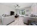 Inviting living room with tile floors, ceiling fan, and sliding glass doors to the outdoor space at 17216 Goldcrest Loop, Clermont, FL 34714