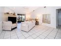 Bright living room featuring tile floors, a fireplace, and sliding glass doors at 1735 Foxhall Cir # 1735, Kissimmee, FL 34741