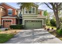 Inviting two-story townhome featuring an attached two-car garage and well-kept landscaping at 2015 Shalimar Loop, Sanford, FL 32773