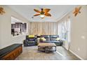 The tile-floored living room is bright, with modern decor and comfortable seating at 2015 Shalimar Loop, Sanford, FL 32773