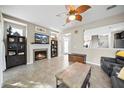 Inviting living room features tile flooring, a fireplace, and a unique ceiling fan at 2015 Shalimar Loop, Sanford, FL 32773