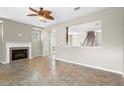 Open-concept living room with fireplace, neutral walls, and access to the stairway and other rooms at 2015 Shalimar Loop, Sanford, FL 32773