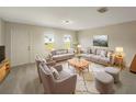 Inviting living room with neutral tones, offering ample seating and a cozy rug, perfect for entertaining or relaxing at 209 Fig Ct, Kissimmee, FL 34759