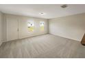 Bright, carpeted living room with lots of natural light, showing a blank canvas for you to personalize and enjoy at 209 Fig Ct, Kissimmee, FL 34759