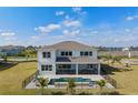 Aerial view of home with pool, fenced yard, patio, and lush lawn perfect for outdoor enjoyment at 2141 Weatherly Way, Orlando, FL 32820