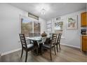 Dining area with lots of light, modern table and chairs, and elegant decorative wall art at 2437 S Cedar Ave, Sanford, FL 32771