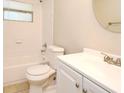 Bright bathroom features a shower and tub combo and a well lit vanity at 2519 Poinsetta Ave, Sanford, FL 32773