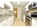 Well-lit kitchen featuring stainless steel appliances, granite countertops, and stylish cabinetry at 2519 Poinsetta Ave, Sanford, FL 32773