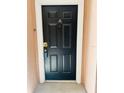 The unit's front door offers security and privacy within this well-maintained condominium community at 3428 Soho St # 308, Orlando, FL 32835