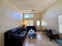 Bright living room featuring high ceilings, tile floors, ceiling fan, and lots of natural light at 3522 Wd Judge Dr, Orlando, FL 32808