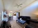 Open-concept living space featuring tile floors that flows into kitchen with breakfast bar at 3522 Wd Judge Dr, Orlando, FL 32808