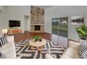 Inviting living room with stone fireplace, wood floors, and sliding glass doors at 3646 Dovetail S Ln, Lakeland, FL 33812