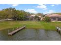 Spacious backyard features a tranquil pond with a dock and screened in lanai, perfect for relaxing outdoors at 3850 Eagle Isle Cir, Kissimmee, FL 34746