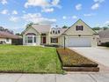 Charming home featuring a well-manicured lawn and attached two car garage at 413 Country Wood Cir, Lake Mary, FL 32746