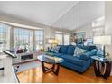 Bright living room with large windows, hardwood floors, and comfortable seating at 413 Country Wood Cir, Lake Mary, FL 32746