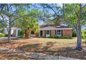 Cozy single-story brick home with mature trees in the front yard at 5325 Glasgow Ave, Orlando, FL 32819