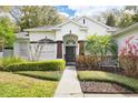 Charming home featuring a well-manicured lawn and inviting front entrance, complemented by mature landscaping at 8176 Emerald Forest Ct, Sanford, FL 32771