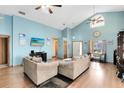 Bright living room featuring vaulted ceilings, hardwood floors, and an abundance of natural light at 835 Longleaf Pine Ct, Orlando, FL 32825