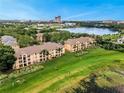 Aerial view of complex with lush green lawns and lake views at 8837 Latrec Ave # 5307, Orlando, FL 32819