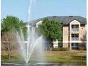 Exterior shot of community buildings with a decorative fountain in the foreground at 8837 Latrec Ave # 5307, Orlando, FL 32819