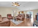 Open-concept living room with hardwood floors, neutral paint, and comfortable seating at 96 Pecan Dr, Ocala, FL 34472