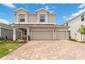 Stunning two-story home featuring a brick driveway, well-manicured lawn, and a welcoming entrance at 1212 Bear Oak Ln, Deland, FL 32720