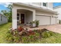 Charming front porch with comfortable seating and colorful flower garden at 1212 Bear Oak Ln, Deland, FL 32720