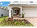 Inviting covered front porch with seating and decorative plants at 1212 Bear Oak Ln, Deland, FL 32720