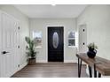 Inviting foyer with a decorative front door, stylish console table, and luxury vinyl plank flooring at 1240 Moton Ave, Sanford, FL 32771