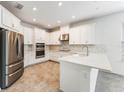 Bright kitchen with white cabinets, stainless steel appliances, and stone countertops at 1344 Blue Stem Lane, Winter Park, FL 32792