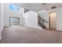 Spacious living room with neutral carpeting, high ceilings, and sliding glass doors to backyard at 1344 Blue Stem Lane, Winter Park, FL 32792