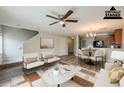 A staged view of a living room featuring stylish furniture, a ceiling fan, and an open layout at 13441 Starry Night Ct # 9, Orlando, FL 32824