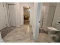 Bathroom featuring tile floor, a glass-enclosed shower, and a doorway to the bedroom at 2006 Myrtle Pine St, Kissimmee, FL 34746