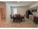 Open dining area features tile floors, a view into the kitchen, and a window for natural light at 2006 Myrtle Pine St, Kissimmee, FL 34746