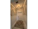 Inviting foyer with detailed accent wall, a decorative light fixture and tiled floor at 2006 Myrtle Pine St, Kissimmee, FL 34746